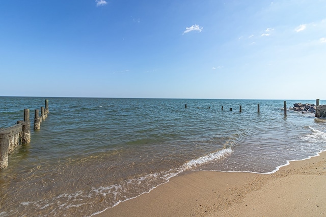 exterior space featuring a water view and a view of the beach