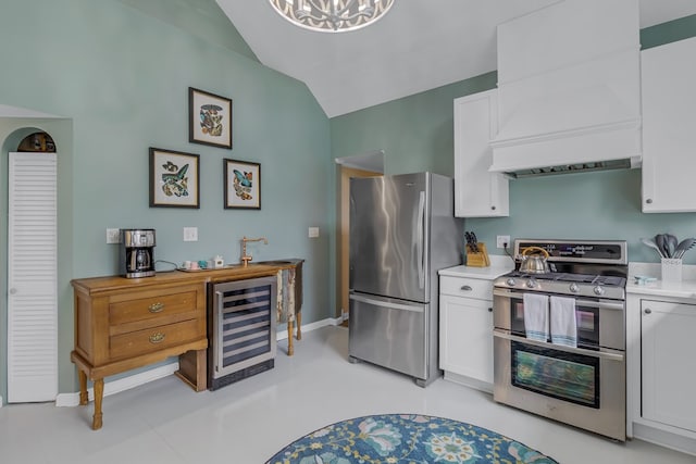 kitchen featuring white cabinets, lofted ceiling, stainless steel appliances, and wine cooler