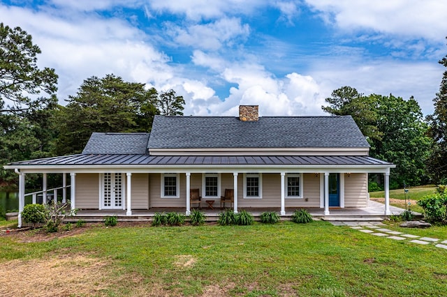 country-style home featuring covered porch and a front yard