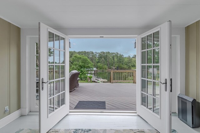 entryway featuring crown molding and french doors