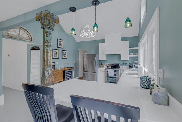 kitchen featuring kitchen peninsula, custom range hood, stainless steel appliances, wine cooler, and hanging light fixtures