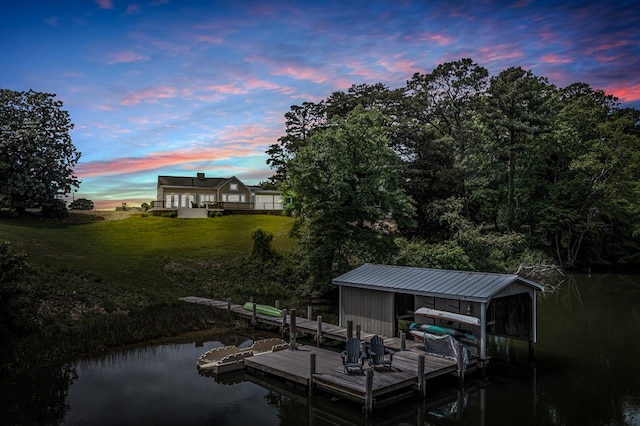 dock area featuring a lawn and a water view