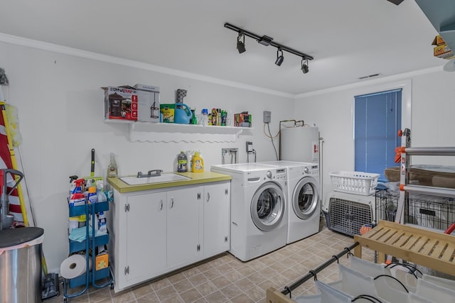 washroom featuring separate washer and dryer, electric water heater, crown molding, and cabinets