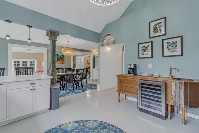 interior space with vaulted ceiling and beverage cooler