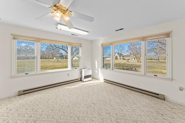 unfurnished room featuring light carpet, a baseboard radiator, visible vents, and a baseboard heating unit