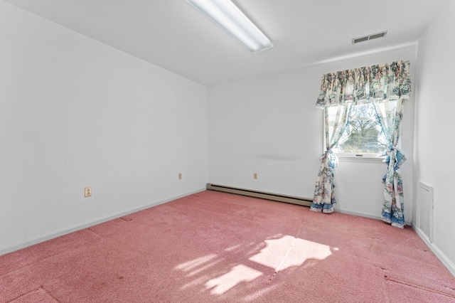 carpeted empty room with a baseboard heating unit, visible vents, and baseboards