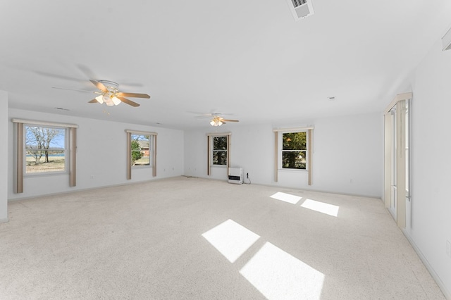 unfurnished living room with light carpet, ceiling fan, and visible vents