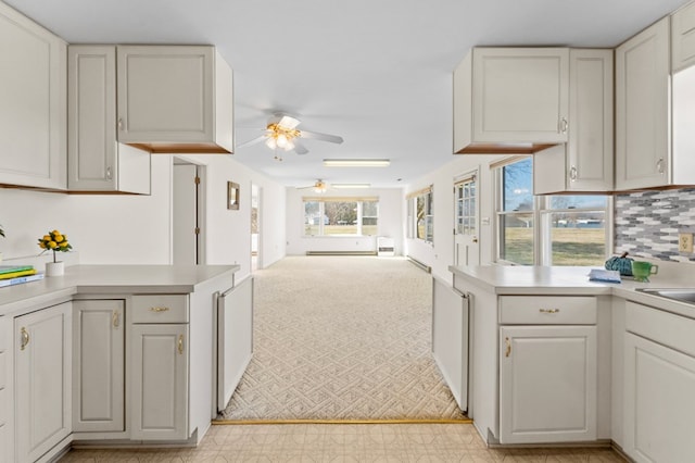 kitchen with white cabinetry, light countertops, and open floor plan