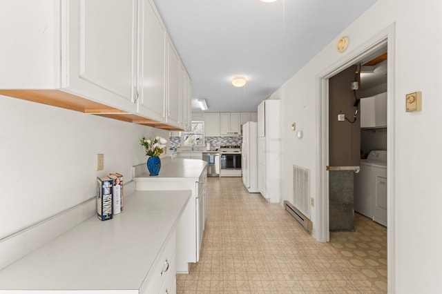 hallway featuring light floors, washer / clothes dryer, a baseboard radiator, and visible vents