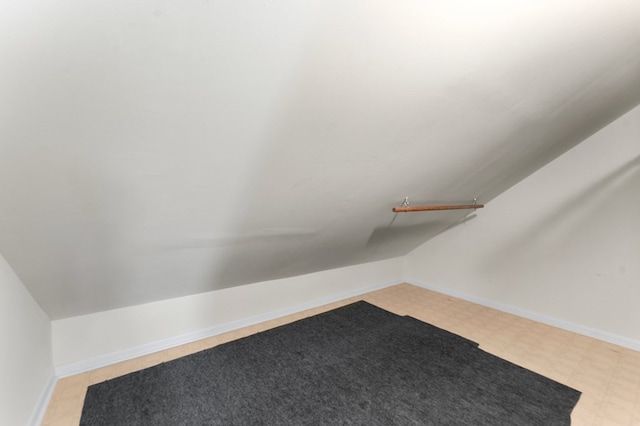 walk in closet with vaulted ceiling and light floors