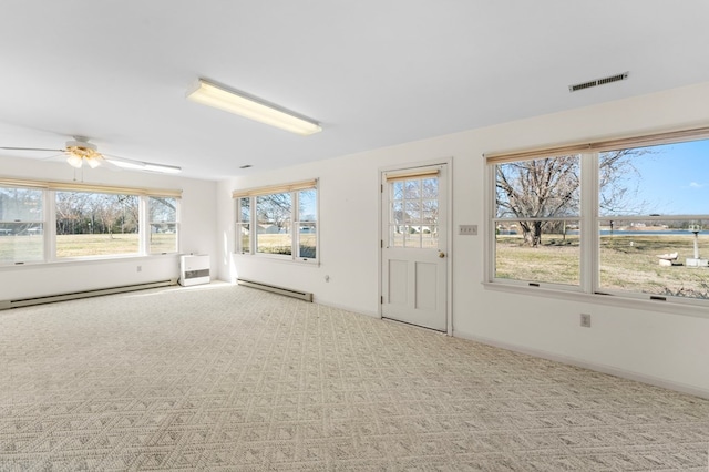 interior space featuring a baseboard radiator, visible vents, and a ceiling fan