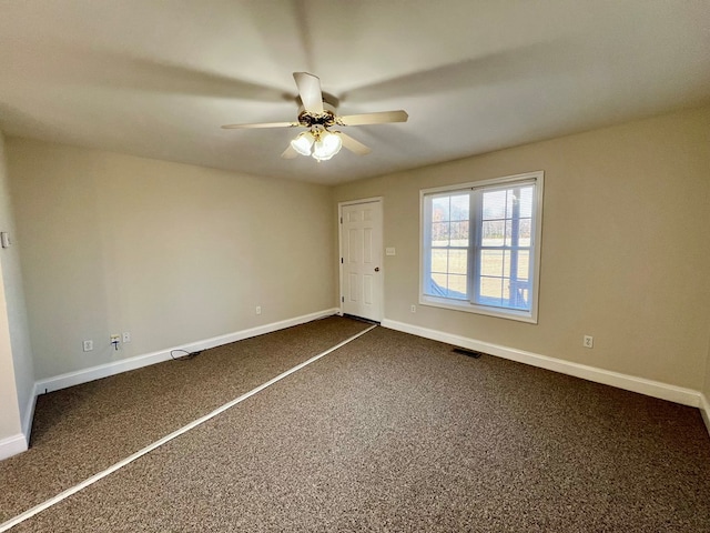 unfurnished bedroom with ceiling fan and dark colored carpet