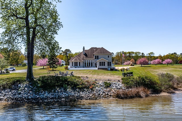 601 Cranes Creek Harbor Dr, Heathsville, VA 22473 - rear view of property featuring a sunroom, a lawn, a water view, and a chimney