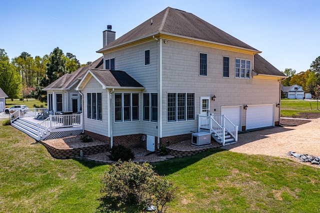 601 Cranes Creek Harbor Dr, Heathsville, VA 22473 - back of property featuring a chimney, a garage, driveway, and a yard
