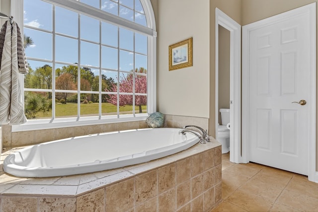 601 Cranes Creek Harbor Dr, Heathsville, VA 22473 - bathroom featuring toilet, a garden tub, and tile patterned floors