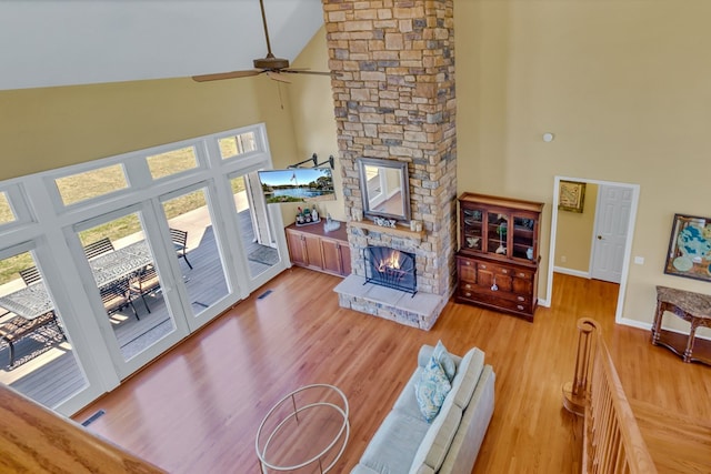 601 Cranes Creek Harbor Dr, Heathsville, VA 22473 - living area featuring high vaulted ceiling, a stone fireplace, healthy amount of natural light, ceiling fan, and baseboards