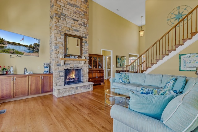 601 Cranes Creek Harbor Dr, Heathsville, VA 22473 - living room with a towering ceiling, wood finished floors, a stone fireplace, and stairway