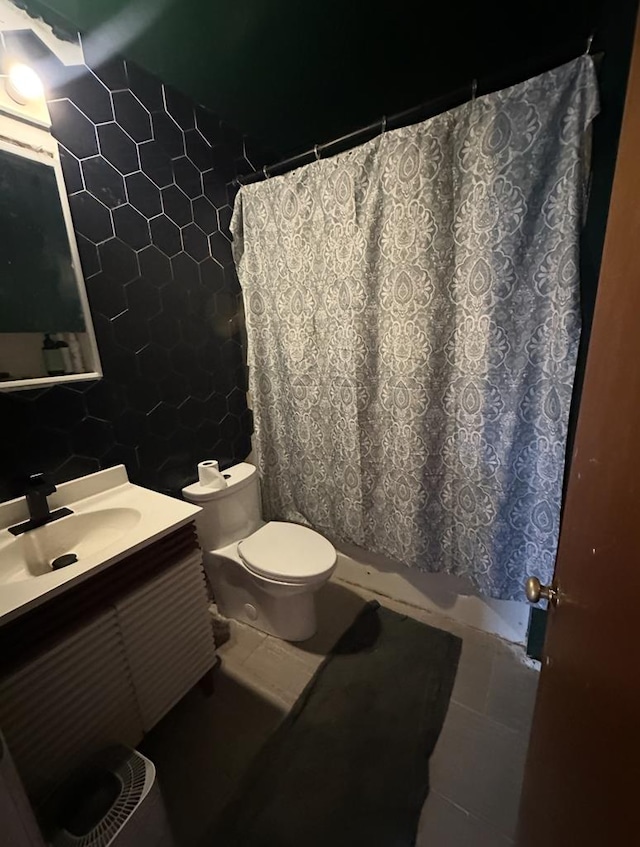 bathroom featuring a shower with curtain, toilet, tile walls, tile patterned flooring, and vanity