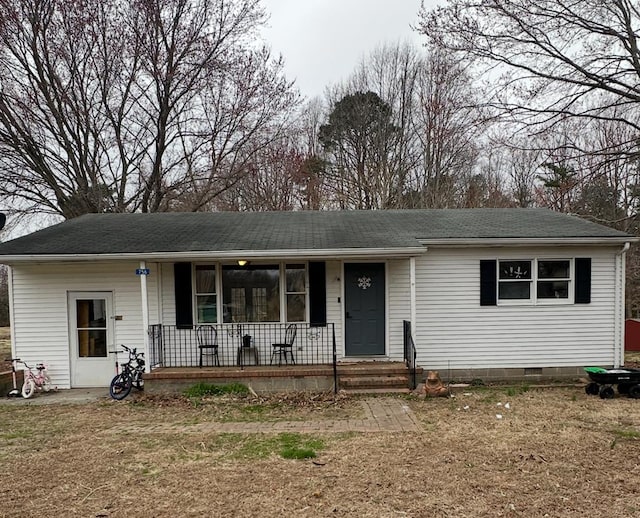 ranch-style home featuring crawl space, covered porch, and roof with shingles