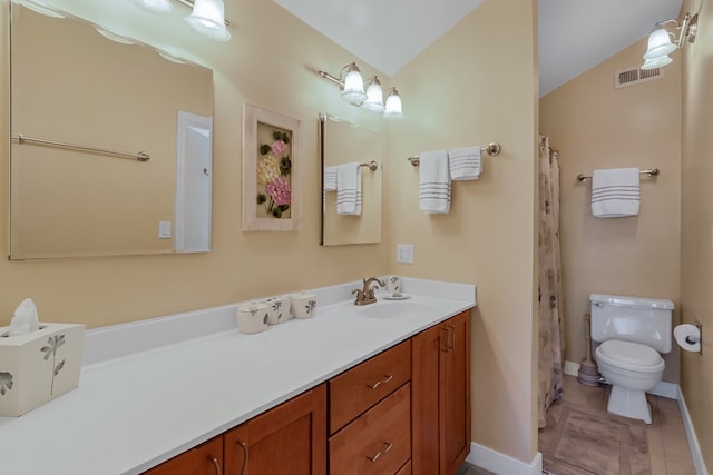 bathroom with vanity, toilet, and tile patterned flooring