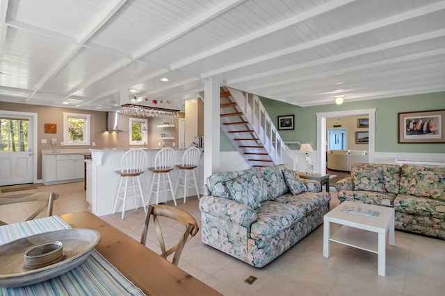 tiled living room featuring beam ceiling