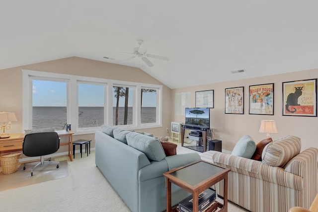 living room with ceiling fan, a wealth of natural light, vaulted ceiling, and carpet flooring