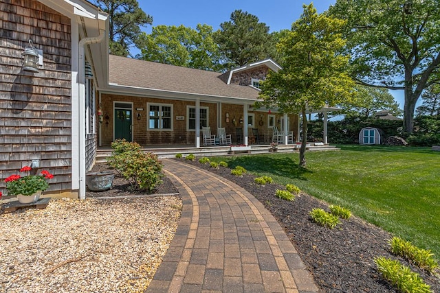 exterior space with a storage shed, covered porch, and a front lawn