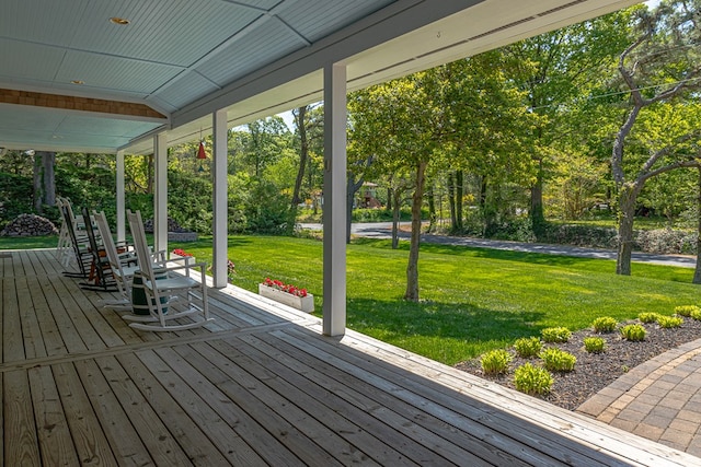 wooden terrace with a lawn