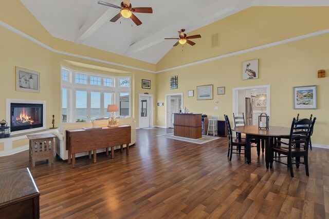 dining room featuring dark wood-type flooring, high vaulted ceiling, and ceiling fan