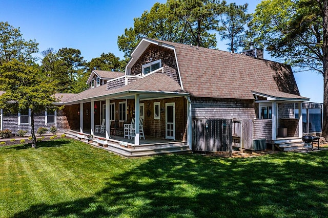 rear view of house with a lawn