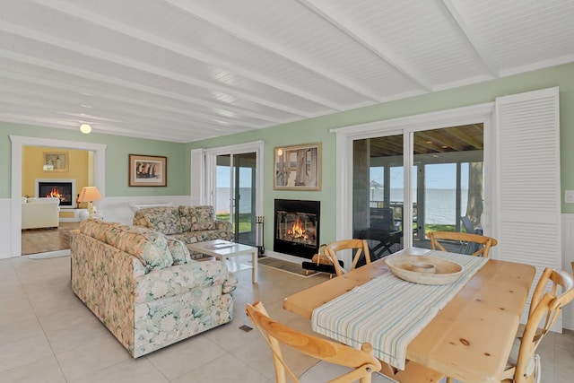 interior space with beamed ceiling and a water view