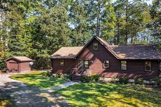 log-style house with a front lawn and a shed