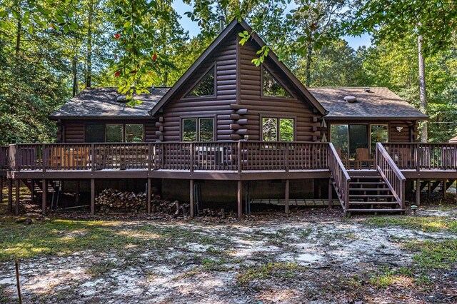 back of house with a deck