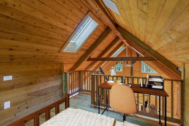 interior space featuring vaulted ceiling with skylight, light wood-type flooring, wooden ceiling, and wooden walls