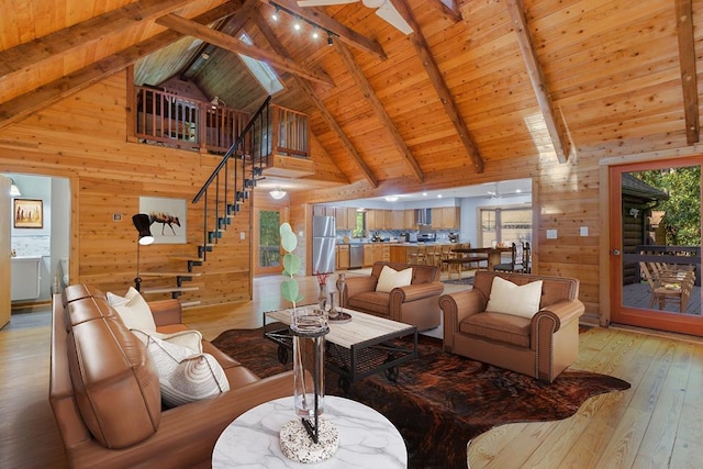 living room featuring wood ceiling, beam ceiling, high vaulted ceiling, light hardwood / wood-style floors, and wood walls