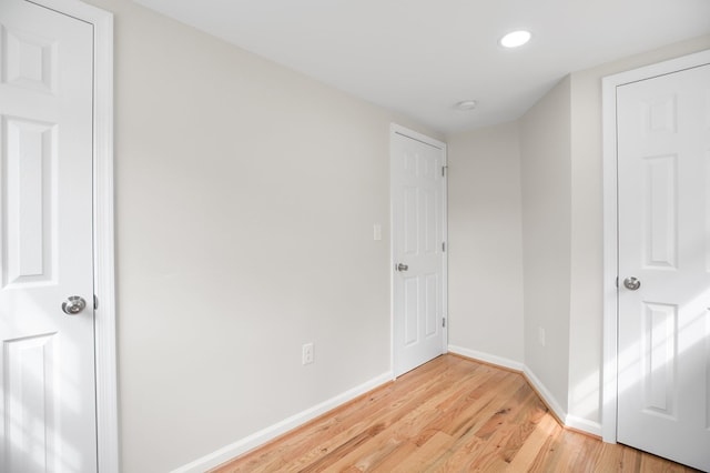 corridor with light hardwood / wood-style floors