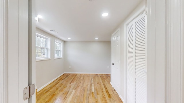 unfurnished bedroom with a closet and light wood-type flooring