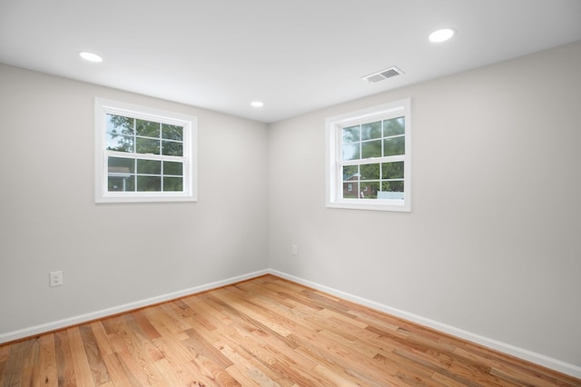 spare room with plenty of natural light and light wood-type flooring