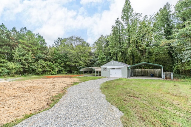 view of yard with a garage, an outdoor structure, and a carport