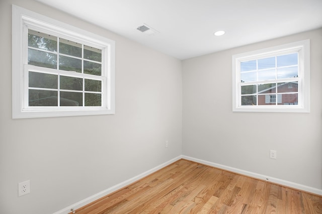 unfurnished room with light hardwood / wood-style flooring