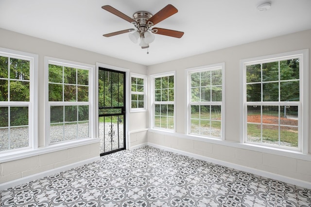 unfurnished sunroom with plenty of natural light and ceiling fan