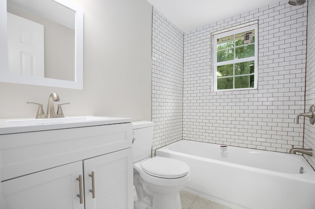 full bathroom with tile patterned flooring, vanity, tiled shower / bath combo, and toilet