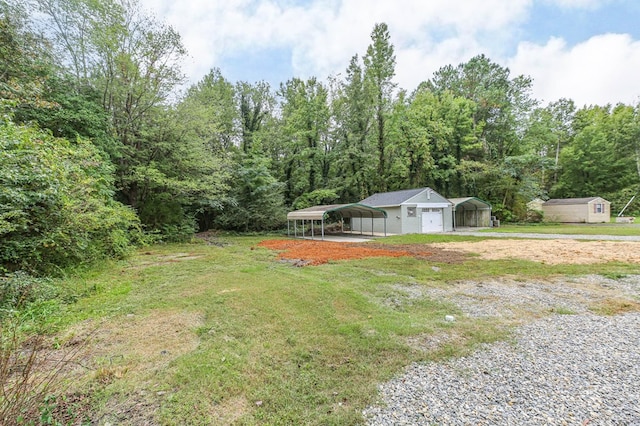 view of yard featuring a carport and a storage unit