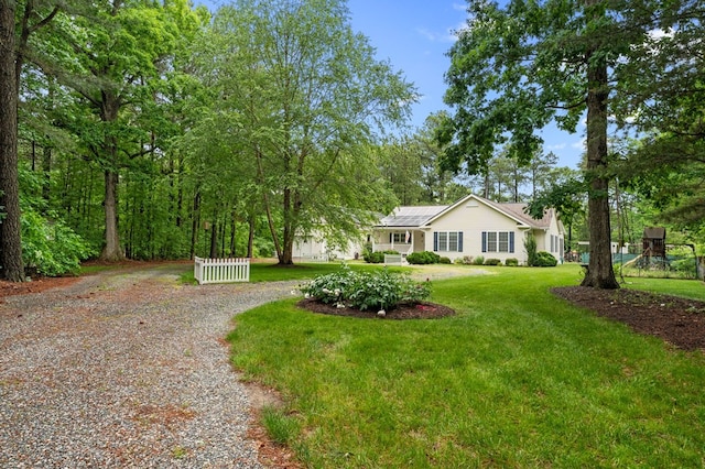 586 Kingscote Dr, Lottsburg, VA 22511 - view of front facade featuring curved driveway, solar panels, and a front lawn