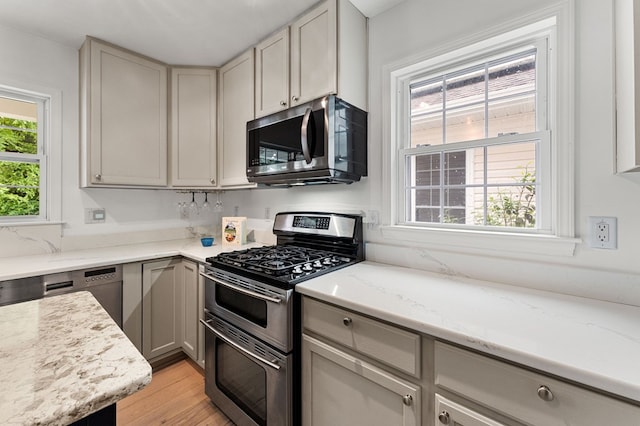 586 Kingscote Dr, Lottsburg, VA 22511 - kitchen with stainless steel appliances, light wood-type flooring, light stone counters, and gray cabinetry