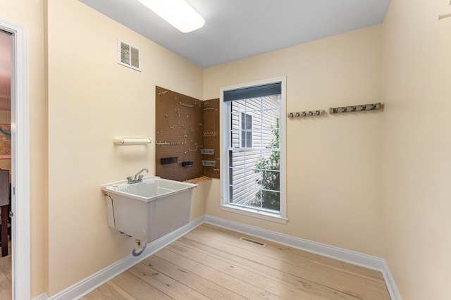 586 Kingscote Dr, Lottsburg, VA 22511 - bathroom featuring hardwood / wood-style flooring and baseboards