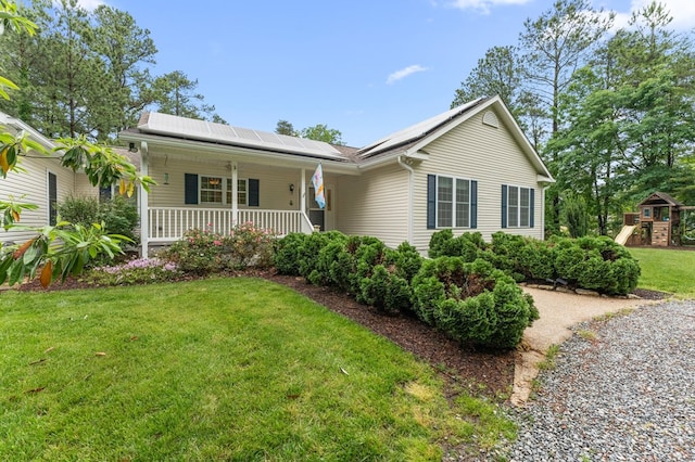 586 Kingscote Dr, Lottsburg, VA 22511 - ranch-style home featuring a porch, a front yard, roof mounted solar panels, and a playground