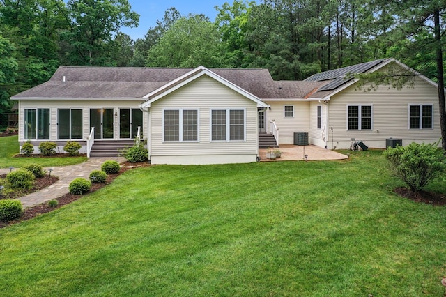 586 Kingscote Dr, Lottsburg, VA 22511 - rear view of property featuring a patio, central air condition unit, and a yard