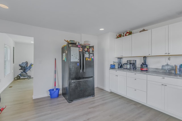 427 Brooks Ln, Callao, VA 22435 - kitchen with black refrigerator, light hardwood / wood-style flooring, and white cabinetry