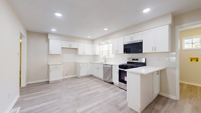 kitchen featuring backsplash, white cabinetry, sink, and stainless steel appliances